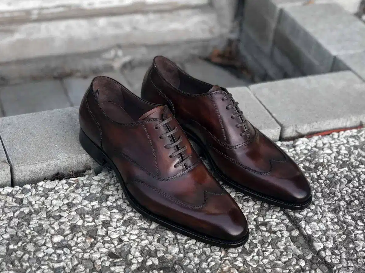 Chi tiết hoàn thiện giày da Kiểm tra kỹ các đường chỉ may và chi tiết đục lỗ hoa văn trên thân giày da
